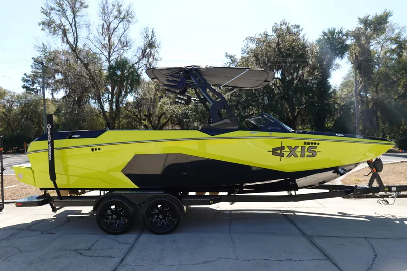 Slide: The Image of 2026 Axis A245 boat in vibrant yellow and black on a trailer, parked outdoors. - 5