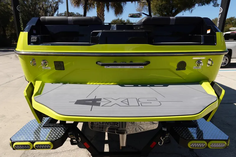 Slide: The Image of 2026 Axis A245 boat rear view with vibrant green finish and branded swim platform. - 8