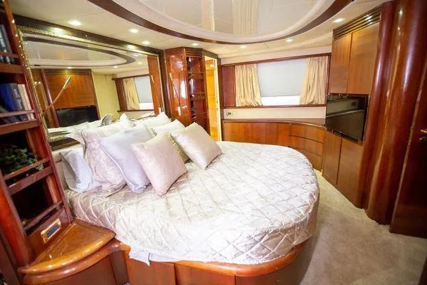 Slide: The Image of Luxurious bedroom interior of 2003 Azimut 74 Solar yacht with elegant wood finishes. - 13