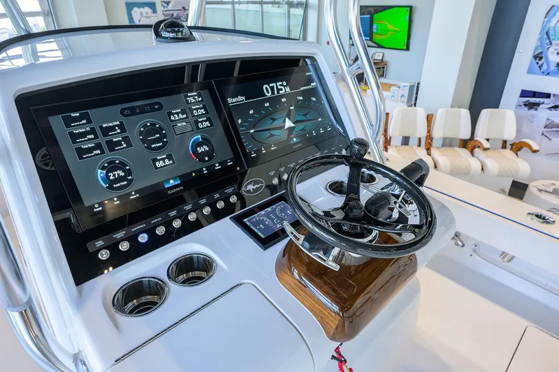 Slide: The Image of 2026 Valhalla Boatworks V-28 Bay dashboard with advanced navigation displays and steering wheel. - 10