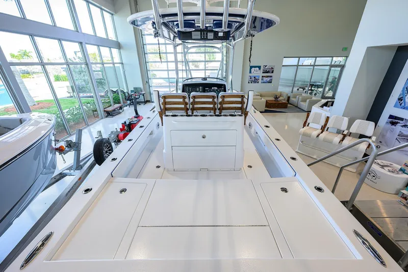 Slide: The Image of 2026 Valhalla Boatworks V-28 Bay interior, showroom display with seating and control panel. - 28