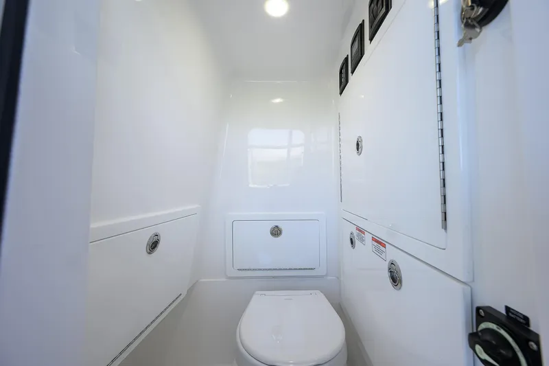 Slide: The Image of 2026 Valhalla Boatworks V-28 Bay interior with sleek white marine bathroom design. - 33