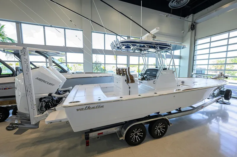 Slide: The Image of 2026 Valhalla Boatworks V-28 Bay in showroom, featuring Mercury engine and sleek design. - 6