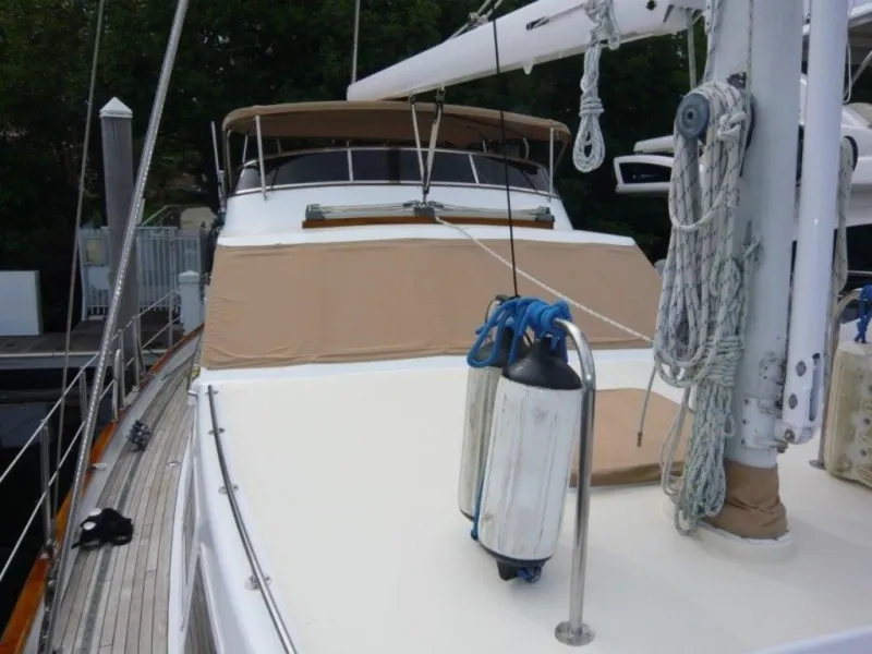 Slide: The Image of 1990 Cheoy Lee Sloop with beige deck cover and mooring fenders. - 10