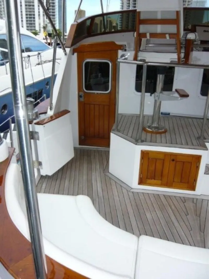 Slide: The Image of 1990 Cheoy Lee Sloop interior with wooden accents and seating area. - 17