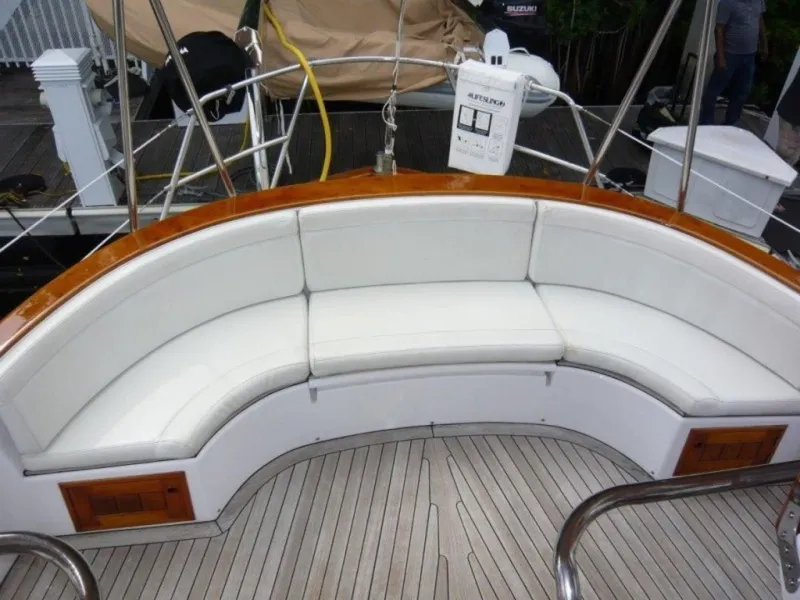 Slide: The Image of 1990 Cheoy Lee Sloop with curved white seating and teak deck. - 18