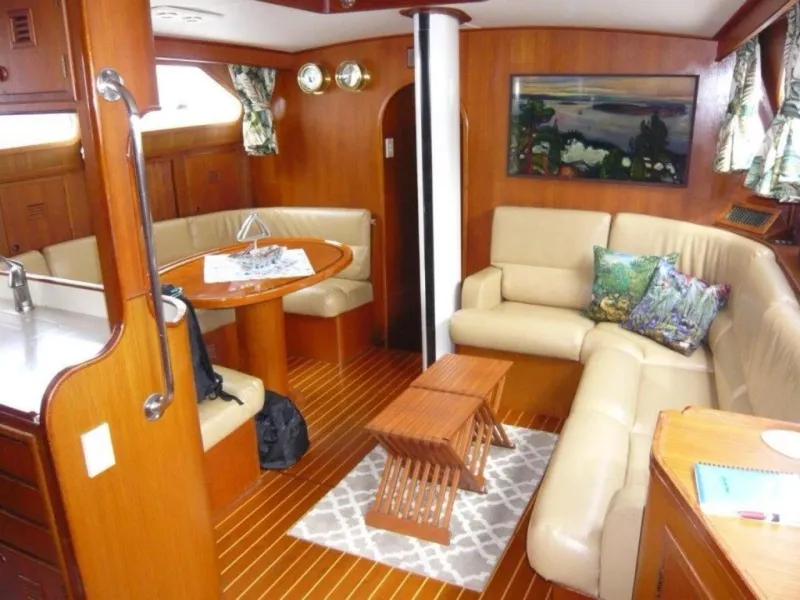 Slide: The Image of Luxurious 1990 Cheoy Lee Sloop interior with wood finish, cozy seating, and nautical decor. - 34