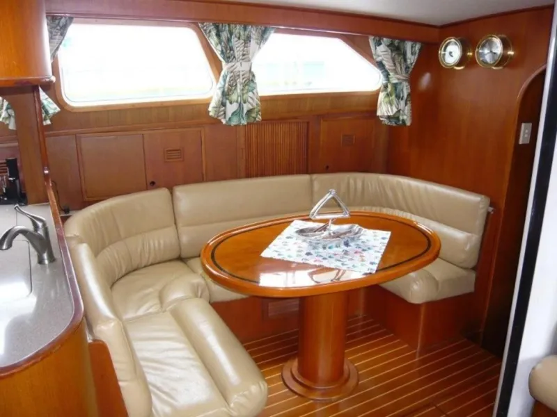 Slide: The Image of Luxurious interior of 1990 Cheoy Lee Sloop with leather seating and wooden table. - 37