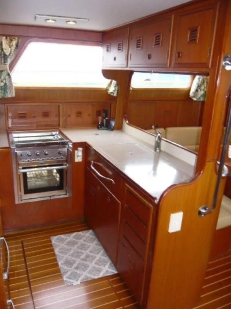Slide: The Image of 1990 Cheoy Lee Sloop interior kitchen with wooden cabinetry and modern appliances. - 39