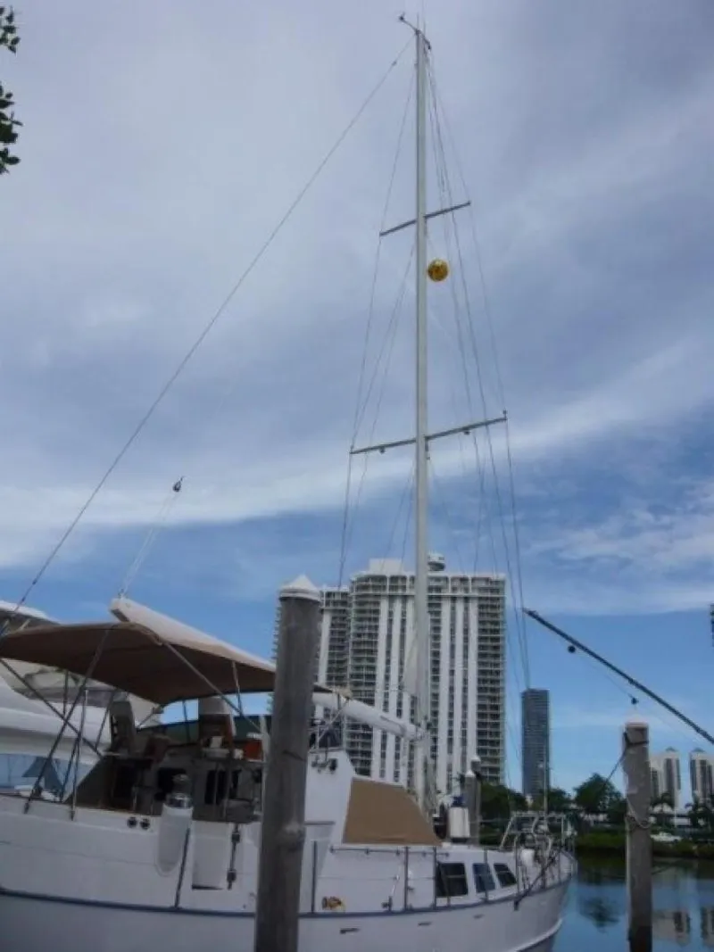 Slide: The Image of 1990 Cheoy Lee Sloop docked with city skyline in background. - 4