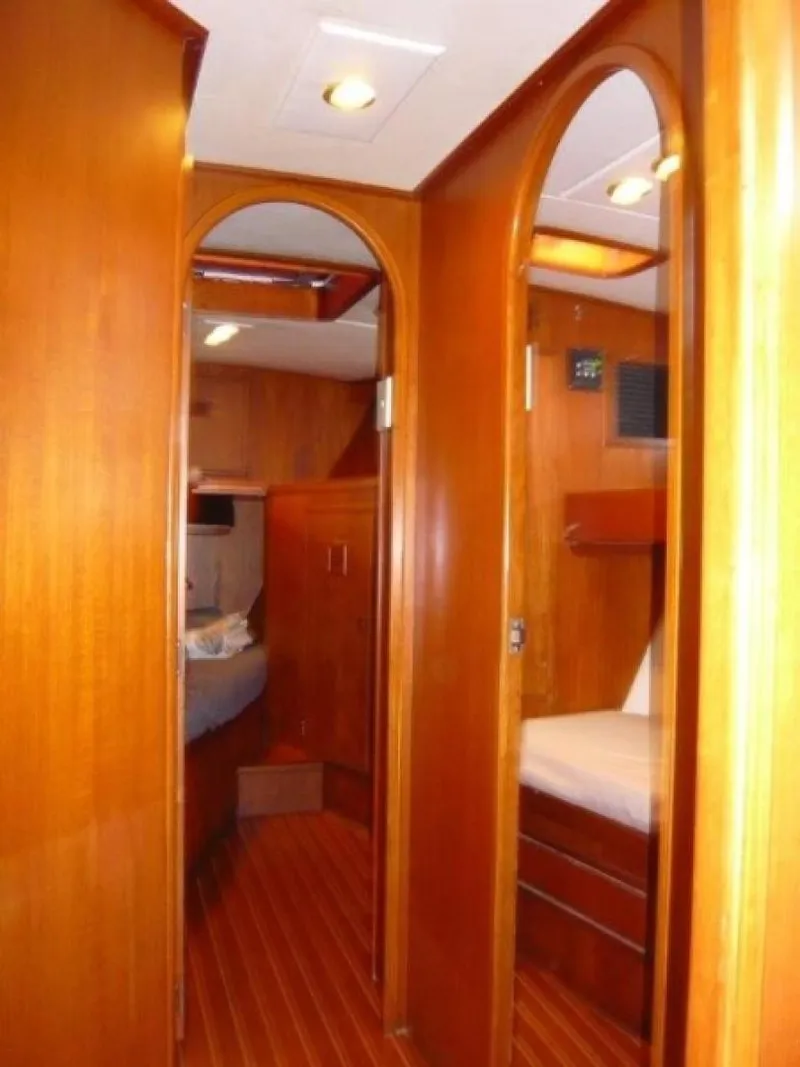 Slide: The Image of Interior of 1990 Cheoy Lee Sloop, featuring wooden paneling and cozy cabin spaces. - 44