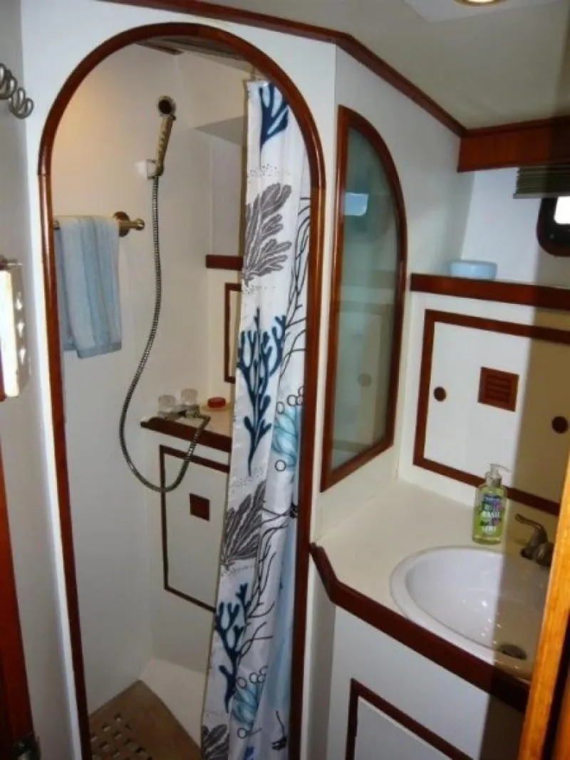 Slide: The Image of 1990 Cheoy Lee Sloop bathroom with shower, sink, and nautical-themed decor. - 47