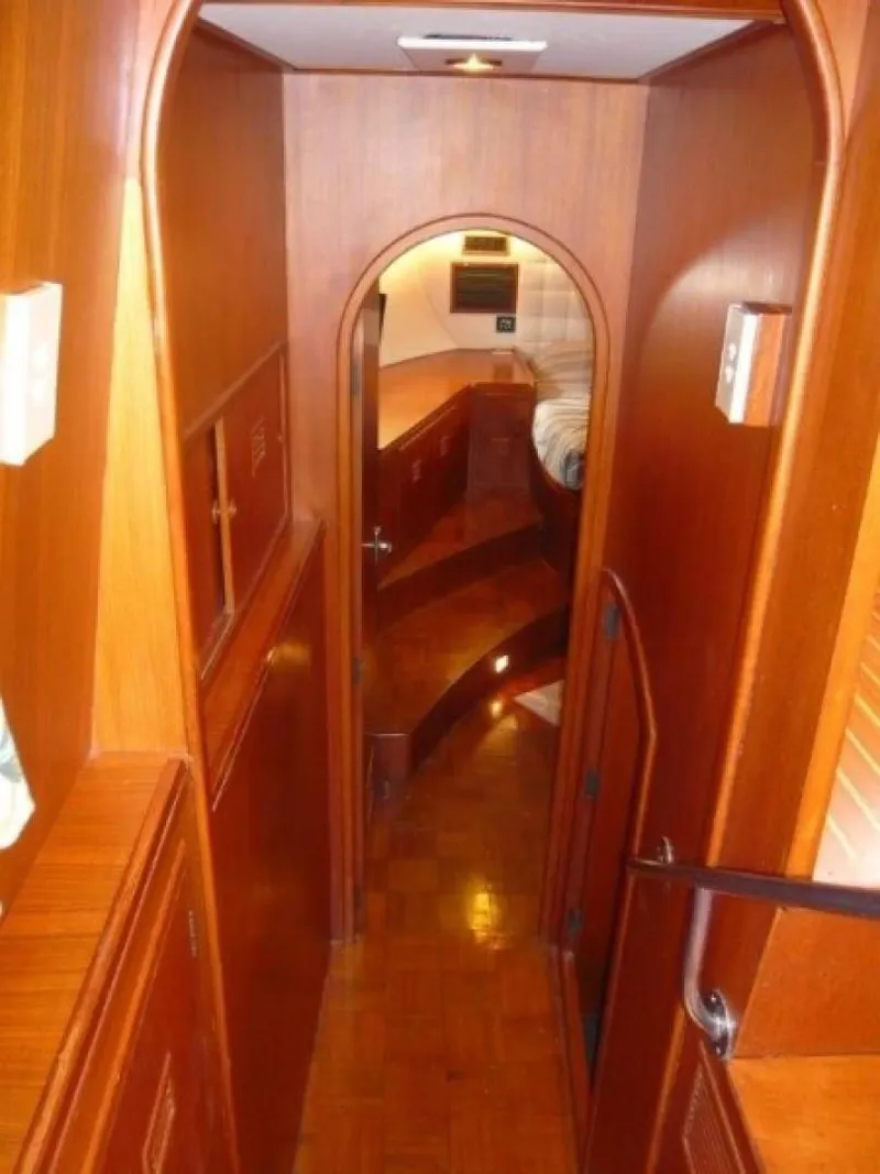 Slide: The Image of Interior of 1990 Cheoy Lee Sloop, featuring wooden paneling and cozy cabin design. - 49