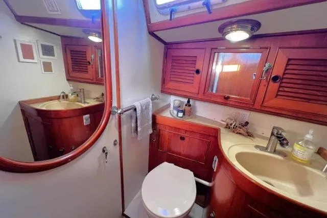 Slide: The Image of Luxurious bathroom in 1988 Hylas Custom 44 yacht with wooden cabinetry and modern fixtures. - 12