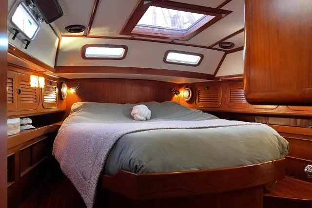 Slide: The Image of Cozy cabin interior of 1988 Hylas Custom 44 sailboat with wood paneling and skylight. - 15