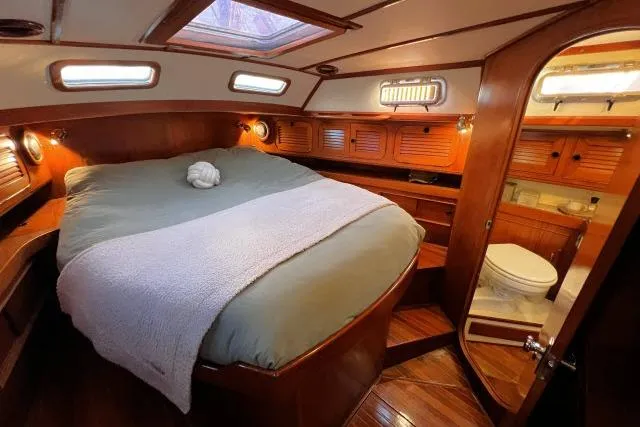 Slide: The Image of Luxurious cabin interior of 1988 Hylas Custom 44 yacht with cozy bed and ensuite bathroom. - 16