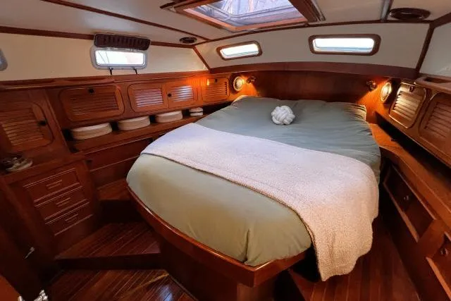 Slide: The Image of Cozy cabin interior of 1988 Hylas Custom 44 yacht with wooden finishes and comfortable bedding. - 17