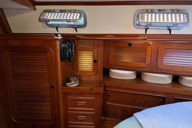 Slide: The Image of Interior of 1988 Hylas Custom 44 yacht with wooden cabinetry and portholes. - 18