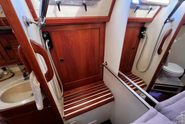 Slide: The Image of 1988 Hylas Custom 44 yacht bathroom with wooden accents and compact design. - 20