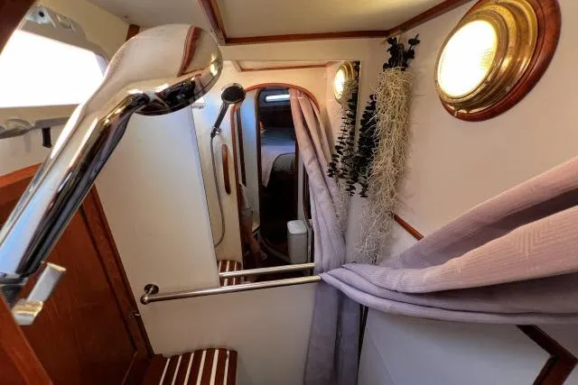 Slide: The Image of 1988 Hylas Custom 44 yacht interior with shower, wooden accents, and nautical decor. - 21