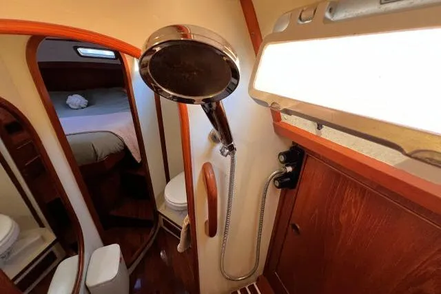 Slide: The Image of 1988 Hylas Custom 44 yacht bathroom with shower, wooden accents, and cozy cabin view. - 22