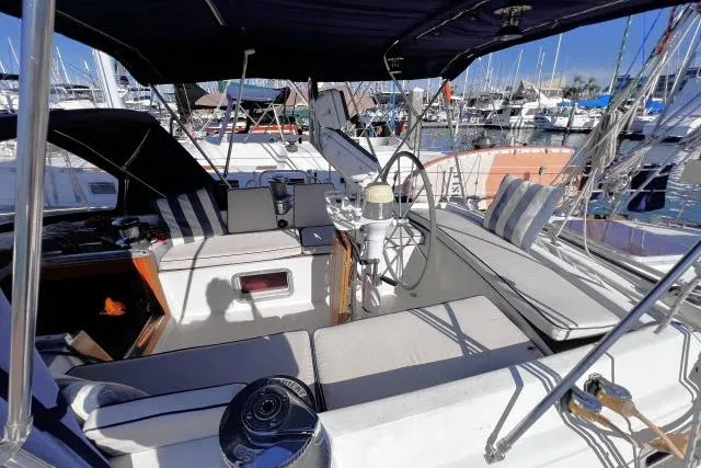 Slide: The Image of Cockpit of 1988 Hylas Custom 44 sailboat with striped cushions and steering wheel. - 27