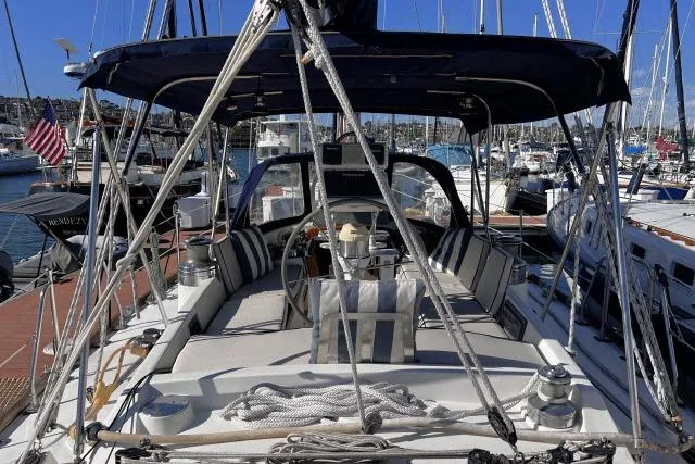 Slide: The Image of 1988 Hylas Custom 44 sailboat docked in marina, featuring spacious cockpit and nautical equipment. - 28