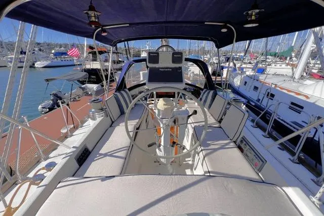 Slide: The Image of 1988 Hylas Custom 44 sailboat cockpit with steering wheel, docked in marina. - 29