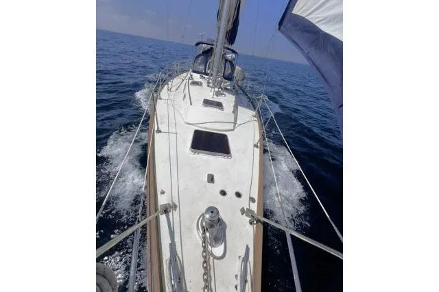 Slide: The Image of Sailing on a 1988 Hylas Custom 44 yacht, cutting through ocean waves. - 38