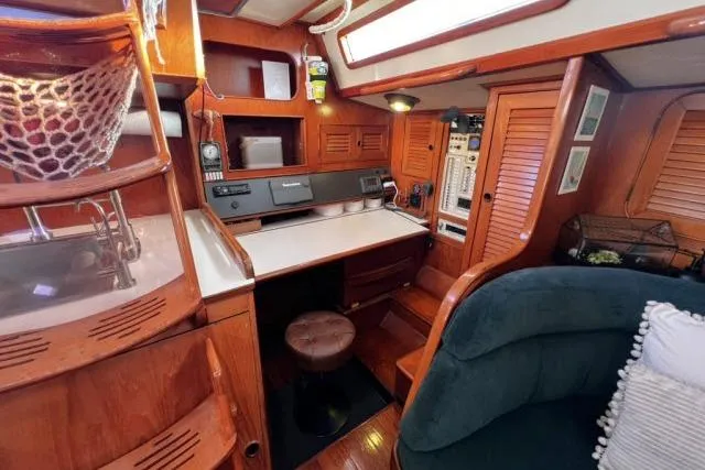 Slide: The Image of 1988 Hylas Custom 44 yacht interior with wooden cabinetry and navigation station. - 4