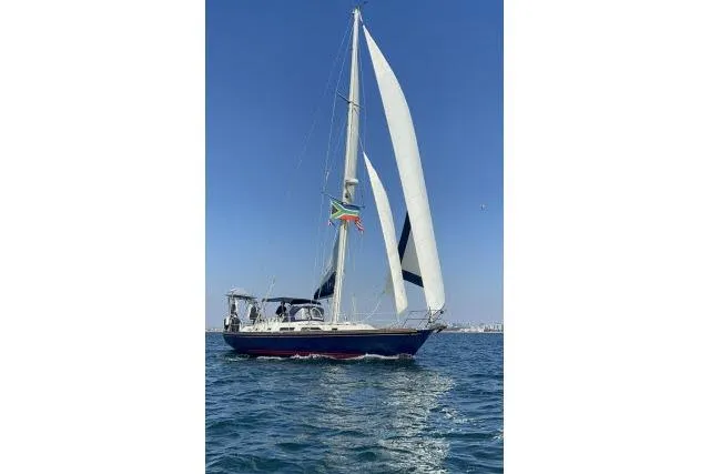 Slide: The Image of Sailing yacht Hylas Custom 44, 1988 model, cruising on open water under clear skies. - 40