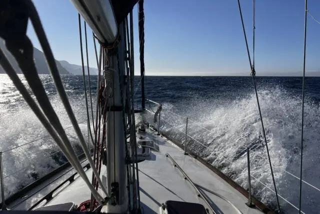 Slide: The Image of Sailing on 1988 Hylas Custom 44 yacht, waves splashing, clear blue sky. - 41