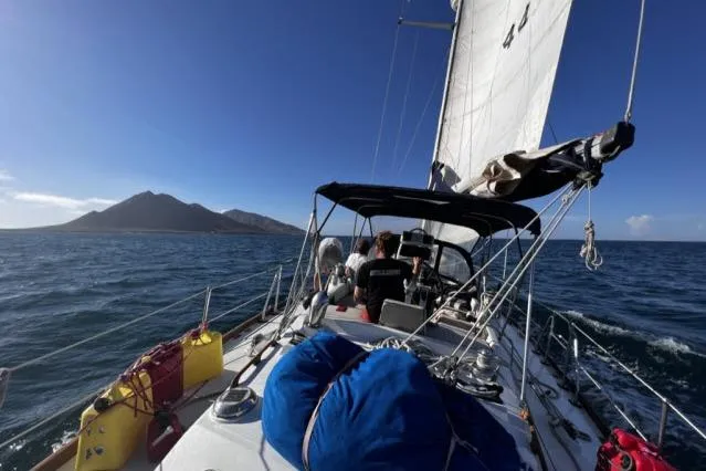 Slide: The Image of Sailing on 1988 Hylas Custom 44 yacht with island view and clear blue sky. - 45
