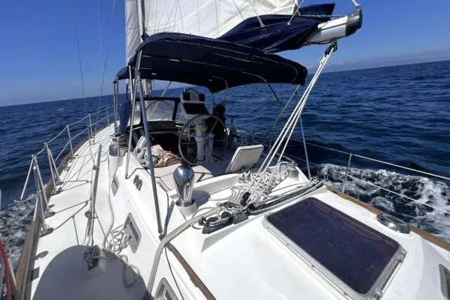Slide: The Image of Sailing on 1988 Hylas Custom 44 yacht in open sea under clear blue sky. - 46