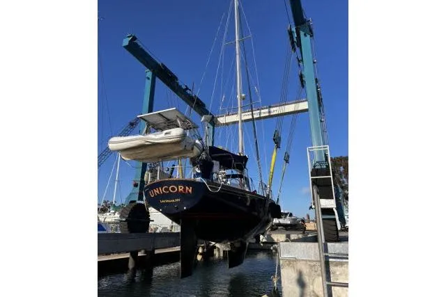 Slide: The Image of 1988 Hylas Custom 44 sailboat, named Unicorn, lifted in a boatyard. - 48