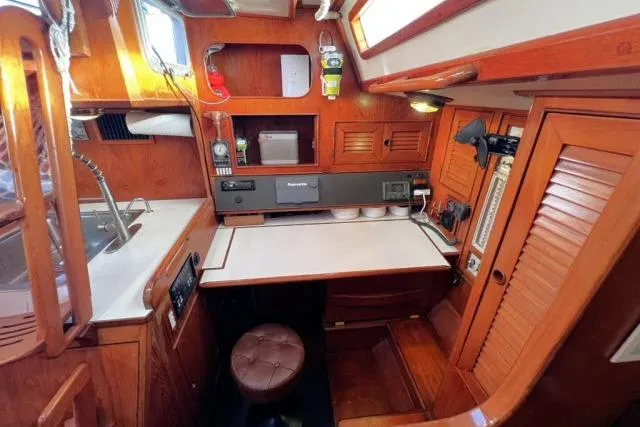 Slide: The Image of 1988 Hylas Custom 44 yacht interior with wooden cabinetry and navigation station. - 5