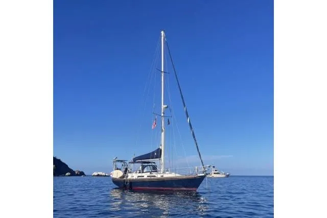 Slide: The Image of Sailboat on calm sea, Hylas Custom 44, 1988 model, under clear blue sky. - 54