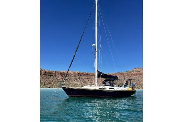 Slide: The Image of 1988 Hylas Custom 44 sailboat on calm water under clear blue sky. - 55