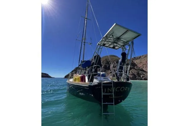 Slide: The Image of Sailboat "Hylas Custom 44" (1988) anchored in clear blue water under sunny sky. - 56