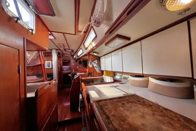 Slide: The Image of Interior of 1988 Hylas Custom 44 yacht, featuring wood cabinetry and spacious layout. - 8