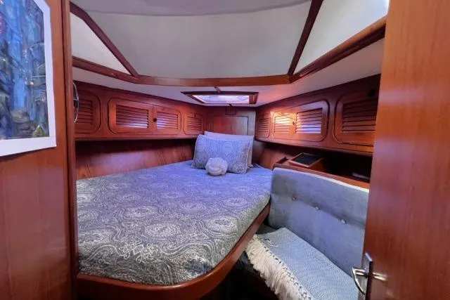 Slide: The Image of Cozy cabin interior of 1988 Hylas Custom 44 sailboat with bed and seating area. - 9