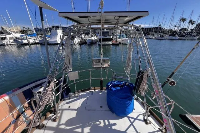 Slide: The Image of Sailboat deck view of 1988 Hylas Custom 44 in marina, with ropes and blue bag. - 33