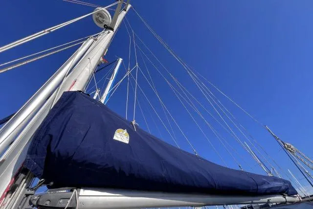 Slide: The Image of Sailboat mast and boom of 1988 Hylas Custom 44 against clear blue sky. - 35