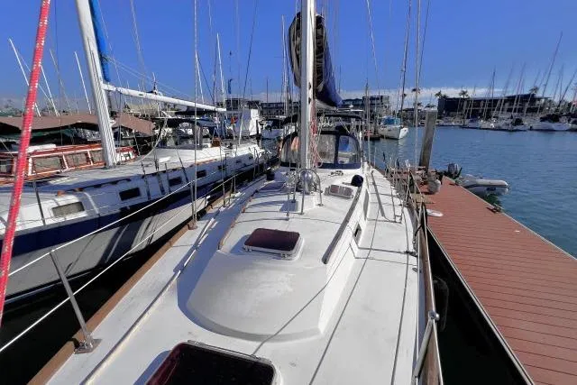 Slide: The Image of 1988 Hylas Custom 44 sailboat docked in a marina, surrounded by other boats. - 36