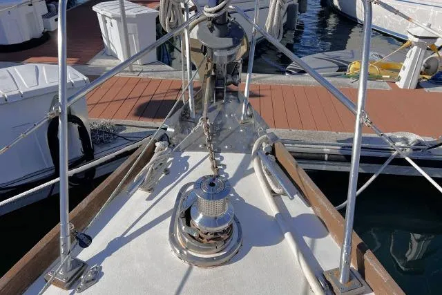 Slide: The Image of Bow of 1988 Hylas Custom 44 sailboat with anchor chain and winch at marina. - 37