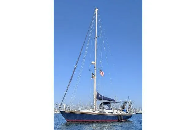 Slide: The Image of 1988 Hylas Custom 44 sailboat on calm water under clear blue sky. - 52