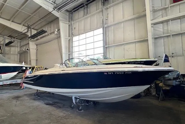 The Image of 2021 Chris-Craft Launch 27 boat in a storage facility, side view. - 0