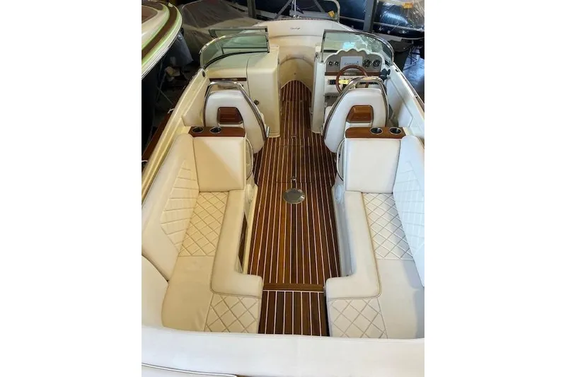 Slide: The Image of 2021 Chris-Craft Launch 27 interior with elegant white seating and wooden flooring. - 12