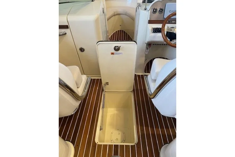 Slide: The Image of 2021 Chris-Craft Launch 27 interior with open storage compartment and elegant wood flooring. - 17