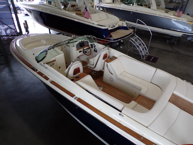 Slide: The Image of 2021 Chris-Craft Launch 27 boat with luxurious interior in a showroom. - 2